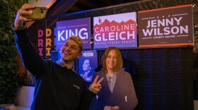 A supporter takes a selfie with a cardboard cutout of Democratic presidential candidate Kamala Harris at an election night watch party at Woodbine Food Hall in Salt Lake City, Nov. 5, 2024.