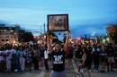 A protester holds a photo of Corey Durell Ruiz as they march Thursday, July 23, 2026, in Madison, Wis., after he was shot and killed by a Madison police officer on Wednesday.