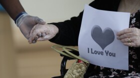 Margaret Choinacki, 87, has no other family members left because her husband and daughter have died. She held the hand of Miami Jewish Health resident care coordinator Anggy Volmar as her friend Frances Reaves drives-by for a visit, Friday, July 17, 2020, at Miami Jewish Health.