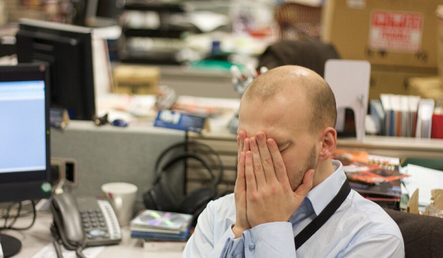 man cries at desk