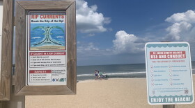An informational sign bringing awareness to the dangers of rip currents is posted at the main entrance of St. Augustine Beach. (Photo by: Caitlyn McLaughlin)