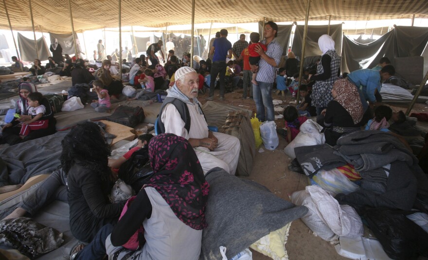 Newly arrived Syrian refugees gather at Zaatari camp, in Mafraq, Jordan, Aug. 29. Residents have rioted over the poor living conditions at the camp. The Jordanian government is not allowing Syrians to leave the camp and join friends or family elsewhere in the country.