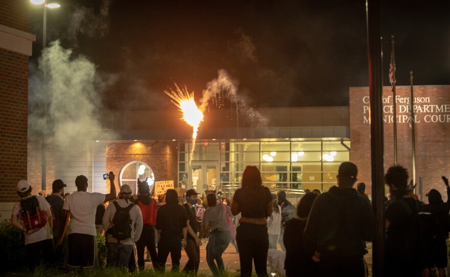 Protesters used a sustained volley of fireworks against police Saturday night at a protest in downtown Ferguson May 30, 2020. Police eventually fired smoke grenades back.