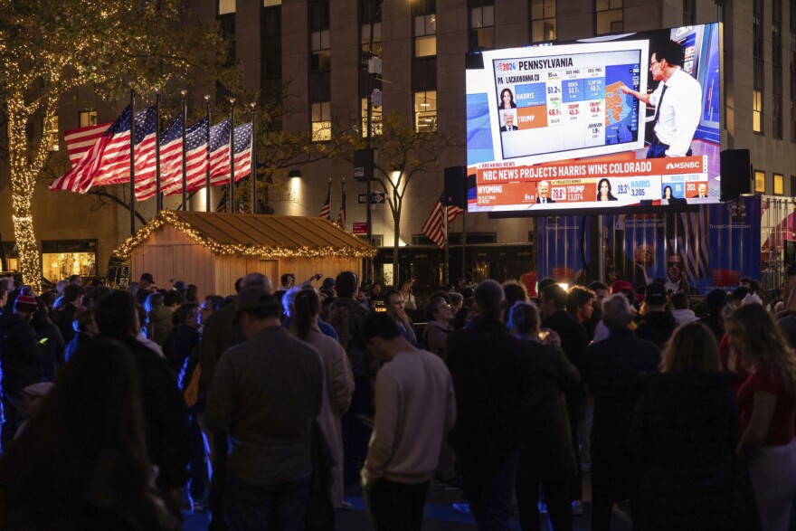 People watch an NBC News livestream showing poll results at Rockefeller Center in New York on Election Day, Tuesday, Nov. 5, 2024.