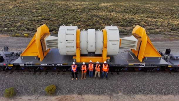 Workers pose with a new train car designed to carry highly-radioactive nuclear waste from power plants around the country. An economic development group in northwest Colorado is entertaining the idea of pursuing a storage facility for the waste.
