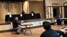 Sumter County Administrator Bradley Arnold (at table on the left) takes part in a County Commission meeting in The Villages Tuesday. Photo: Joe Byrnes