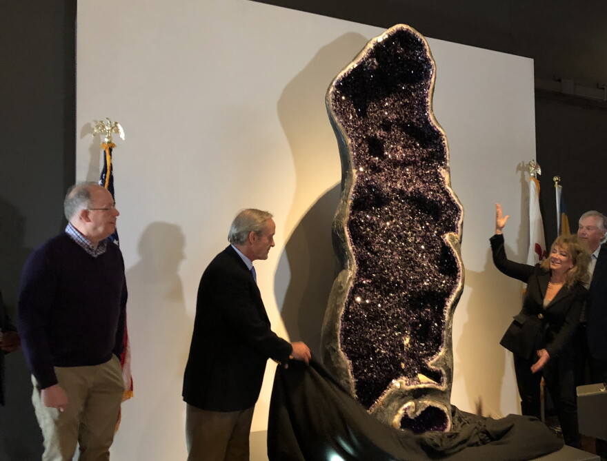During a 10th anniversary celebration Thursday, Peoria Riverfront Museum representatives unveil a 10-foot amethyst geode added to the museum's permanent collection.