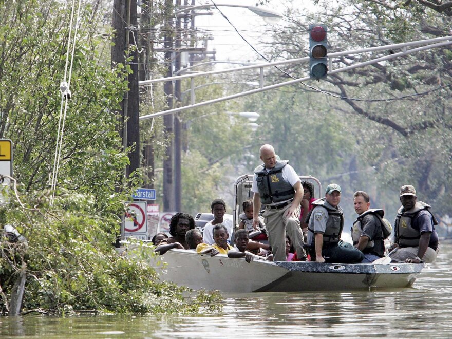 People are taken ashore in a boat after being rescued from their homes after Hurricane Katrina August 30, 2005 in New Orleans, Louisiana.