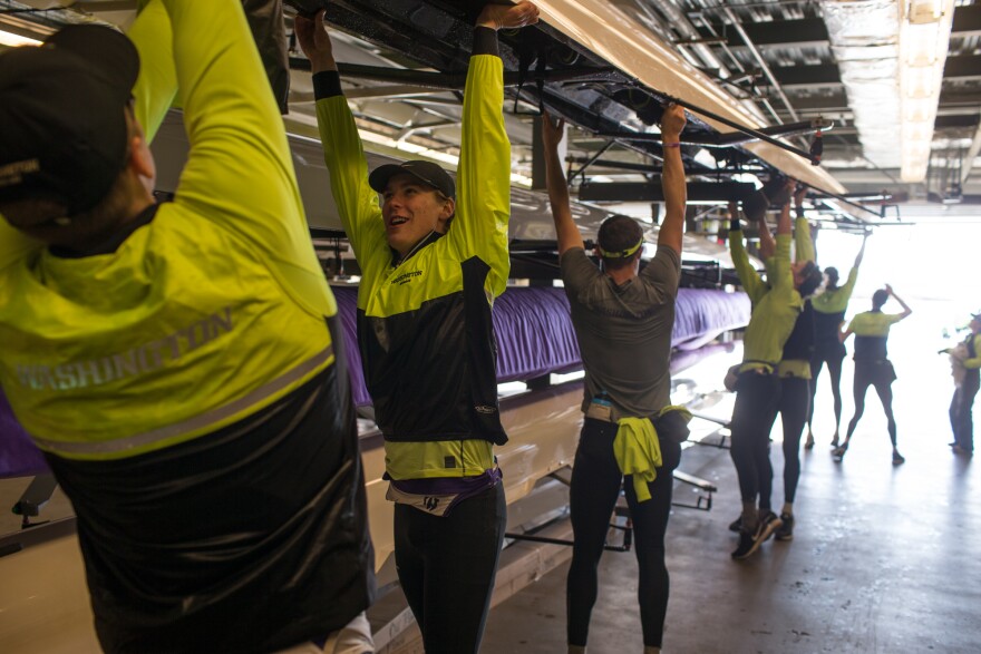 The University of Washington Men's Rowing team prepares for an early morning practice.