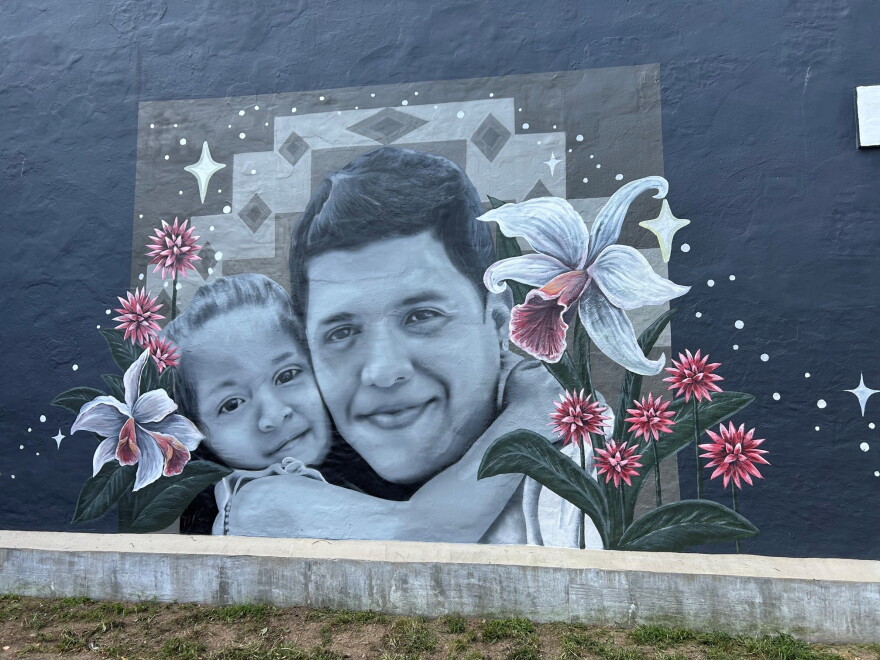 A mural of Johan Sebastian Guererro and his daughter on a building in Biddeford.