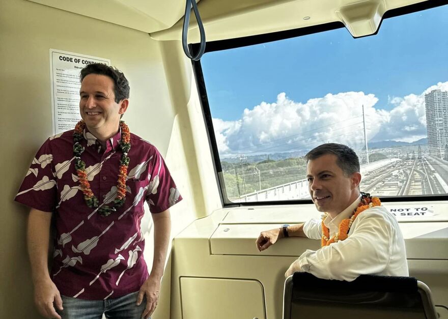 U.S. Sen. Brian Schatz, left, and U.S. Secretary of Transportation Pete Buttigieg on the Honolulu rail on Feb. 22, 2024.