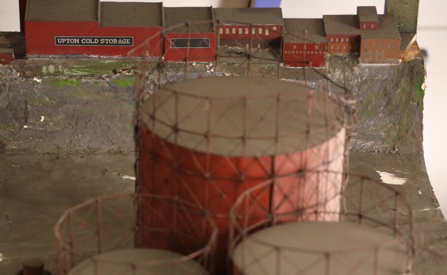 A diorama of the Genesee River gorge circa 1910 depicts the old coal gas storage tanks beside Rochester Gas & Electric buildings. Upton Cold Storage is up on the ridge.