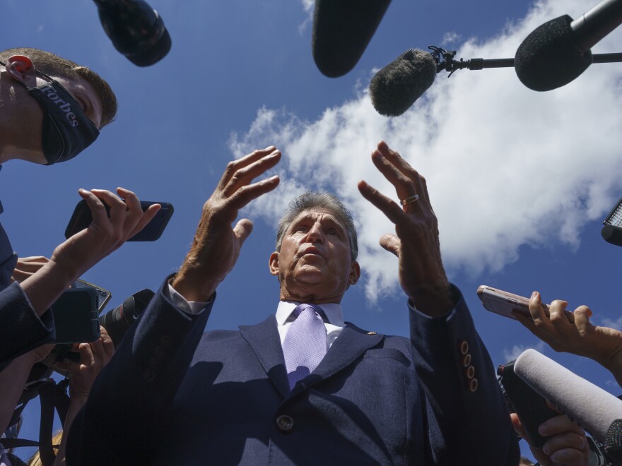 Sen. Joe Manchin, D-W.Va., speaks with reporters on Capitol Hill on Sept. 30, 2021.