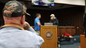 An audience member watches Troy Roberts, the communication and outreach manager for the Suwannee River Water Management District, and John. S. Quarterman, with the Suwannee Riverkeeper at WWALS Watershed Coalition, speak before the meeting on Feb. 5, 2026.