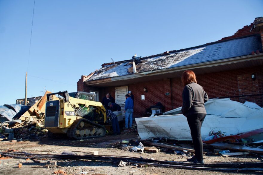 Nanc Gunn stands in front of what was once the Ice House on Dec. 20, 2021 as crews work to recover a statue.