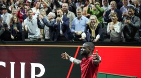 Team World's Frances Tiafoe celebrates after winning the singles tennis match against Team Europe's Stefanos Tsitsipas on the third day of the Laver Cup tennis tournament at the O2 arena in London, Sunday, Sept. 25, 2022. (AP Photo/Kin Cheung)