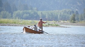 A drift boat with people fly fishing floats down the Yellowstone River, Friday, July 31, 2026, near Livingston, Montana.