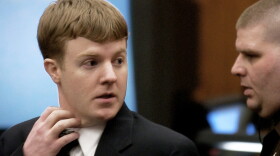 Justin Michael Wolfe, left, looks back towards his parents as he is led from the courtroom by a sheriff's deputy after being found guilty of capital murder in Manassas, Va., Jan. 22, 2002.