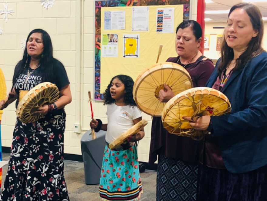 Amy Westcott (far right) holds drumming instrument along with other students at district staff at an event hosted through the Native Education Program at Grand Rapids Public Schools.