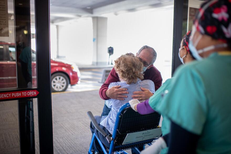 Celeste Marx greets her husband, Len, after spending more than three weeks at St. Luke's Hospital in Chesterfield.