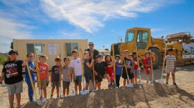 Price Elementary teacher Christina Hall and her students pose with shovels at the groundbreaking site of their new school.