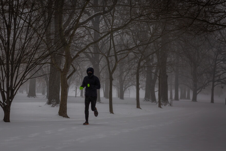 A runner jogs through Tower Grove Park on Monday. A winter storm warning is in effect until 6 a.m. Tuesday.