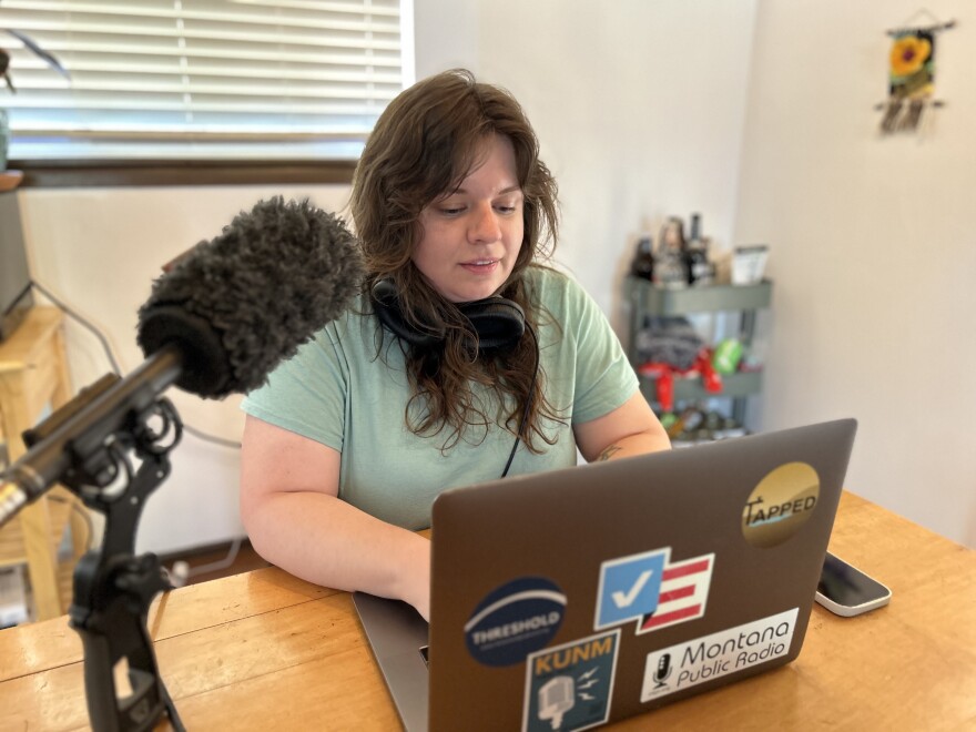 KUNM's newest reporter Megan Myscofski works from her home in Santa Fe on May 9, 2023. She'll focus on topics of public health, poverty and equity through her position funded in part by the W.K. Kellogg Foundation.