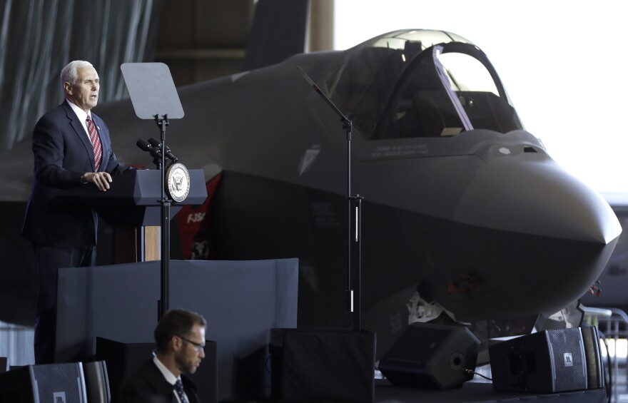 Vice President Pence addresses U.S. military personnel in front of an Air Force F-35 fighter at U.S. Yokota Air Base, on the outskirts of Tokyo, on Feb. 8. The military will be buying an additional 90 F-35s this year; the aircraft is its most modern — and most expensive — fighter jet.