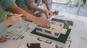 architects and engineers are discussing the design and structure of the upcoming building with the foreman to ensure that they understand the details on the same page, brainstorming, blueprint