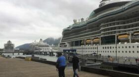 Passengers walk a downtown Juneau dock where three cruise ships are tied up June 11, 2017. (Photo by Ed Schoenfeld/CoastAlaska News)