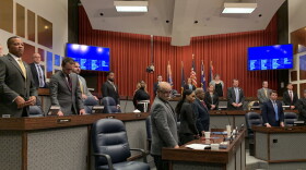 Members of the Indianapolis City-County Council stand to be sworn in during the first meeting of 2020.