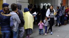 In this Jan. 31, 2019, file photo, hundreds of people overflow onto the sidewalk in a line snaking around the block outside a U.S. immigration office with numerous courtrooms in San Francisco. (Eric Risberg, File/AP)