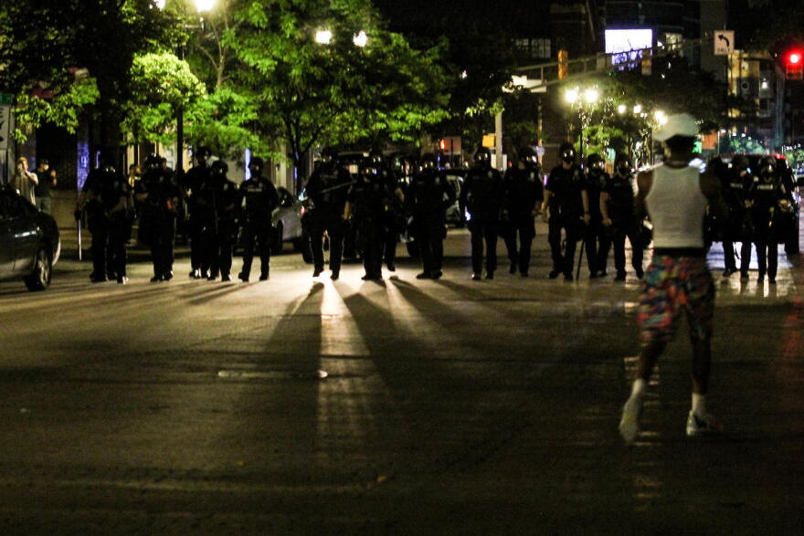 Police march on the gathering at Delaware and Market streets in downtown Indianapolis, blocking traffic. Shortly after, they deployed tear gas, flares and pepper spray pellets at protesters.