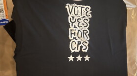 A freshly printed T-shirt reads "Vote Yes for C-P-S."