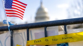 A ribbon reading "Peace to Our Nation" is visible at a memorial for Capitol Police Officer Brian D. Sicknick near the Capitol Building on Capitol Hill in Washington, Thursday, Jan. 14, 2021. (AP Photo/Andrew Harnik)