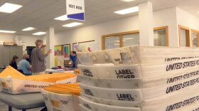Election workers in Monroe County prepare mail-in ballots. The county has received a record number already and is expecting more.