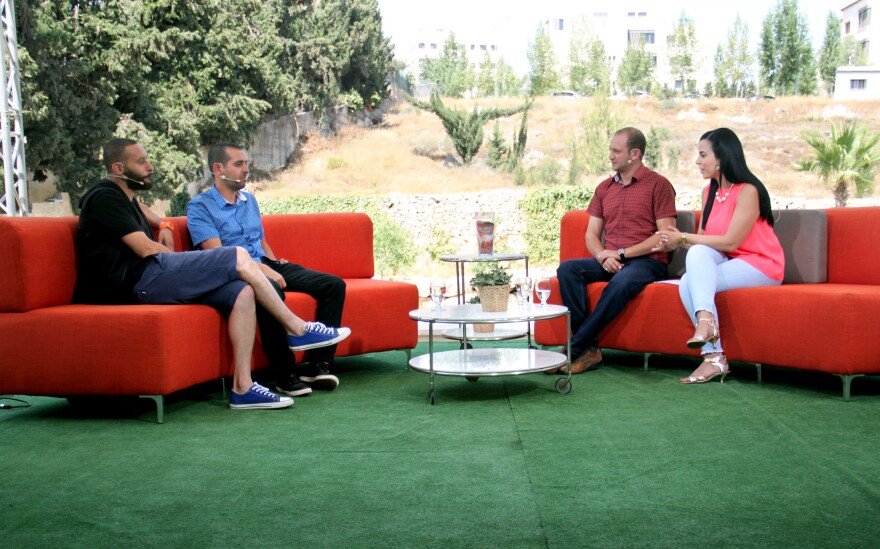 Doraid Liddawi and his co-host, Afaf Shini, interview Palestinian Arab rappers and citizens of Israel on the makeshift Ramallah set of Palestine 48's morning show.