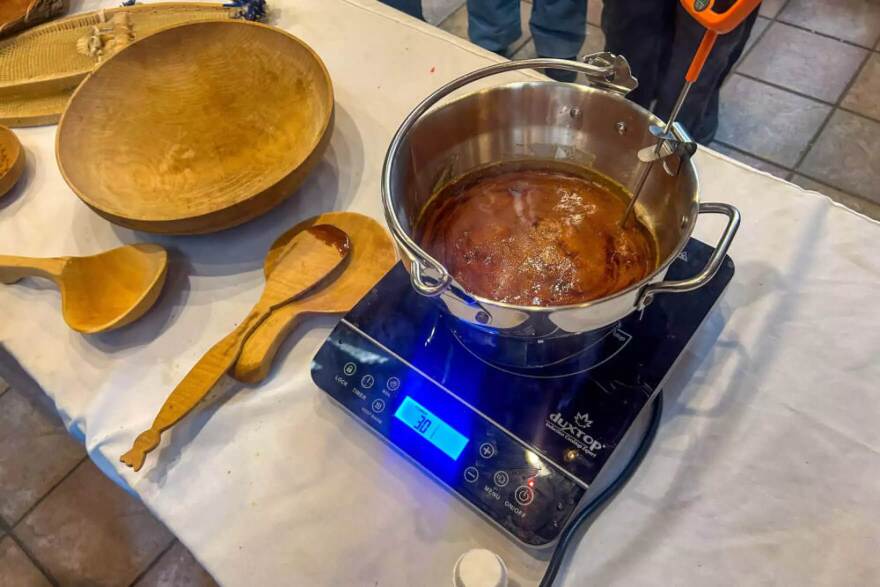 It takes around 40 gallons of sap to make just one gallon of syrup. The dark brown maple syrup needs to boil and reach 250 degrees.