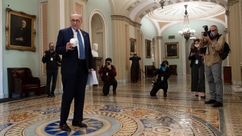 Senate Minority Leader Chuck Schumer, D-N.Y., speaks with the press at the Capitol on Tuesday, before the Senate approved more coronavirus relief aid.