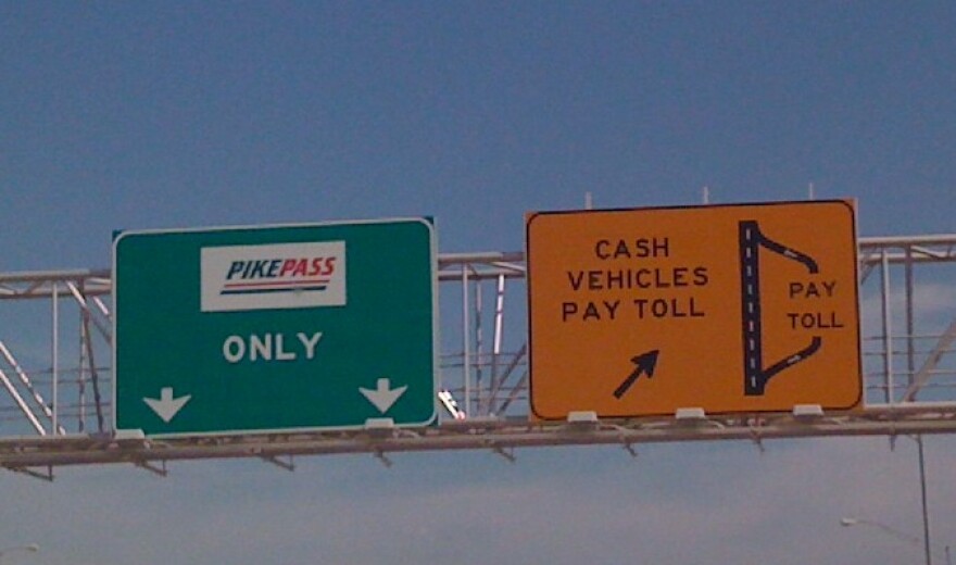 Signs on the Creek Turnpike telling motorists it is time to pay.