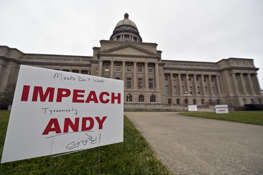 Signs, some with personal messages promoting the impeachment of Kentucky Governor Andy Beshear line the walkway and lawn of the State Capitol building in Frankfort, Ky., Tuesday, Jan. 5, 2021.