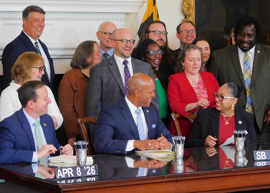 From left to right: Senate President Bill Ferguson, Gov. Wes Moore and House Speaker Joseline Peña-Melnyk sign the three-bill fiscal year 2027 budget package on Wednesday in the Governor's Reception Room in Annapolis, Md.
