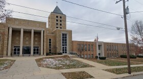 A church and a school, made of brick, on a snowy day