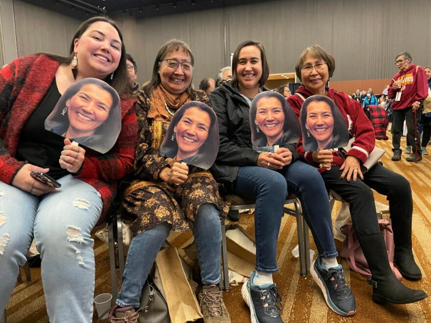Fans of Congresswoman Mary Peltola hold Peltola fans at AFN.