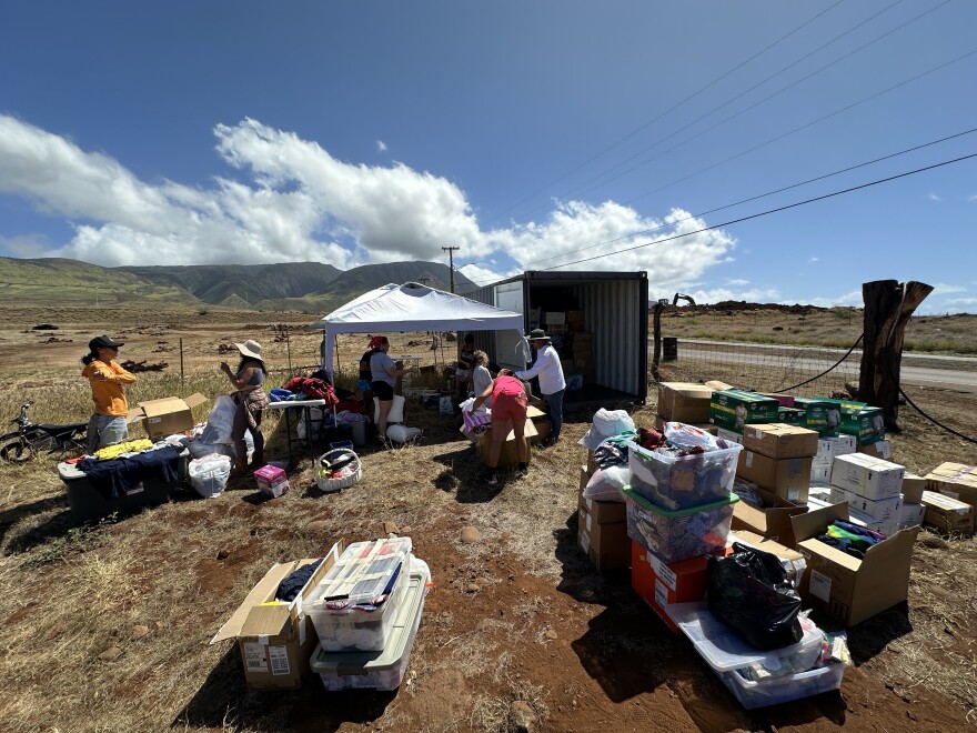 Circular Hawaii volunteers sort the contents of a 20-foot container of clothing and supplies in Lahaina that was donated after the wildfire.