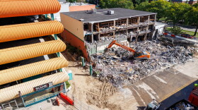 Demolition crews tear down the former Spartan Bookstore in East Lansing, Mich., on Sept. 14, 2026. A new apartment high-rise will be built on the site.
