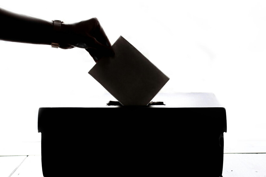 Ballot box with vote being cast image