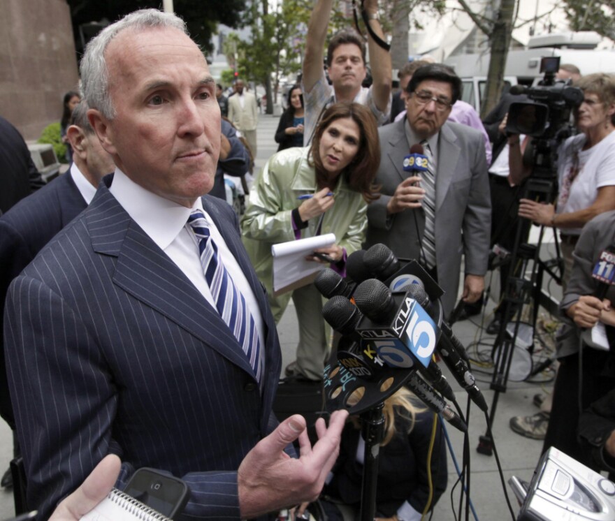 Los Angeles Dodgers' owner Frank McCourt speaks to the media outside court in Los Angeles earlier this month. McCourt cited Major League Baseball Commissioner Bud Selig's interference with club operations and refusal to approve a Dodgers TV deal with Fox Sports as the cause for Monday's bankruptcy filing.