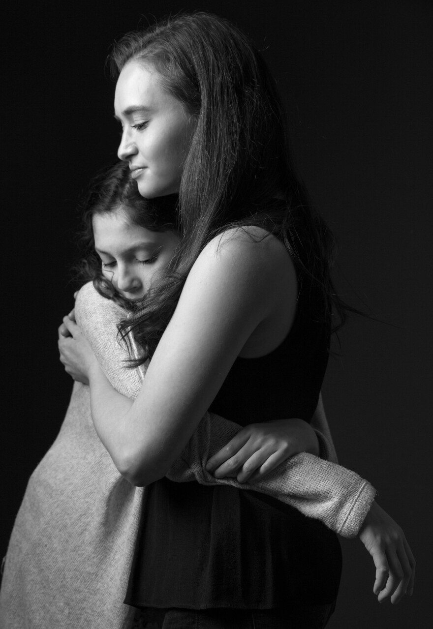 Lola and photographer Moriah Ratner share a quiet moment. The two considered each other close friends. Ratner says sometimes Lola would grow sad, knowing that "the only reason" she met Ratner was because of her sickness.