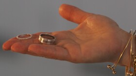 FILE - A marriage official offers a couple their rings during their wedding at the Empire State Building in New York.